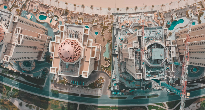 Aerial view of a modern urban district with high-rise buildings, waterways, and intricate road networks, demonstrating the Pegasus TRK Neo’s capability in mapping large-scale urban environments for smart city planning and development.